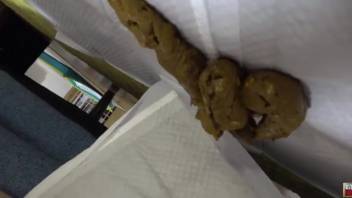 Attractive Asian female defecating on the couch