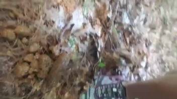 Young woman forcefully defecates in the forest