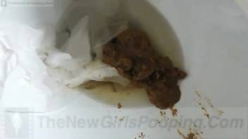 A young woman defecating in a toilet. Zoomed-in view 2