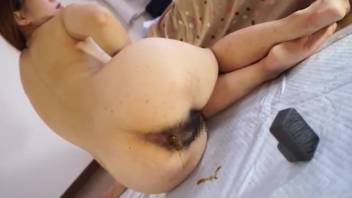 Adorable Asian chick with bushy rear end defecating